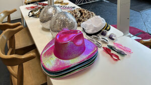 Photo booth props including disco balls, novelty sunglasses and iridescent hats